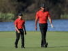 Tiger Woods and Charlie Woods walk down the 18th hole during the final round of the PNC Championship at the Ritz Carlton Golf Club Grande Lakes on December 19, 2021 in Orlando, Florida.