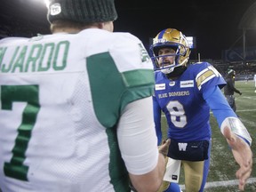 Saskatchewan Roughriders quarterback Cody Fajardo, left, and the Winnipeg Blue Bombers' Zach Collaros shake hands after Sunday's CFL West Division final. Winnipeg won 21-17 to advance to the 108th Grey Cup game, against the host Hamilton Tiger-Cats.