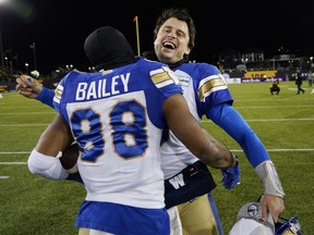 Winnipeg Blue Bombers quarterback Zach Collaros (8) celebrates with receiver Rasheed Bailey (88) after defeating the Hamilton Tiger-Cats 33-25 in overtime in Sunday's Grey Cup game.