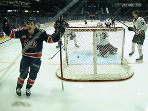 The Regina Pats' Tanner Howe, left, celebrates one of the two goals he scored during Friday's 6-5 victory over the visiting Moose Jaw Warriors.