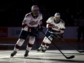 Regina Pats' Jaxsin Vaughan, left, and Corbin Vaughan, right, are shown in the pre-game warmup on Monday at the Brandt Centre, where the Pats played host to the Edmonton Oil Kings. The Vaughans, who are twin brothers, made their WHL debuts on Monday.