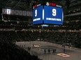 Fans stand for a moment of silence to honour New York Islanders and Regina Pats legend before Friday's game against the Toronto Maple Leafs in Elmont, N.Y. Gillies died Friday at age 67.