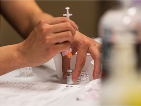 A nurse draws a dose of Pfizer-BioNTech vaccine at the Saskatoon Tribal Council COVID-19 vaccine clinic in the Sasktel Centre on April 9, 2021.