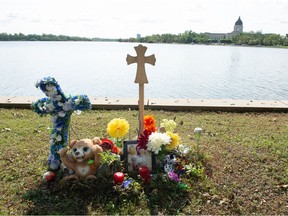 A photograph of Samwel Uko, a man who was found dead in Wascana Lake, is seen at a memorial for him set up on the lake’s edge in Regina, Saskatchewan on Sept. 3, 2021.