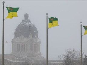 Flags flap in the brisk wind, with the Saskatchewan Legislative Building in the distance on Friday, January 7, 2022 in Regina. Environment Canada issued a blowing snow advisory for the City of Regina on Friday, with reduced visibility in some areas. Winds driven in by a low pressure system were gusting 40-60 km-h. Blowing snow advisories are issued when visibility is reduced to 800 metres or less for at least three hours.
