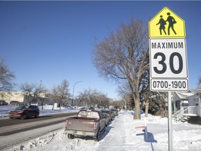 A school zone sign indicating the speed limit of 30 km/h from 7 a.m. to 7 p.m. on Winnipeg Street.