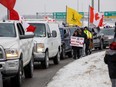 Supporters of a convoy of truckers driving from British Columbia to Ottawa in protest of a Covid-19 vaccine mandate for cross-border truckers gather near a highway overpass outside of Toronto, Ontario, Canada, January, 27, 2022. - A convoy of truckers started off from Vancouver on January 23, 2022 on its way to protest against the mandate in the capital city of Ottawa.