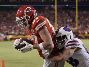 Kansas City Chiefs tight end Travis Kelce, left, catches an eight-yard, game-winning touchdown pass over Buffalo Bills linebacker Matt Milano in NFL divisional-round playoff action Sunday. The Chiefs won 42-36 in overtime.