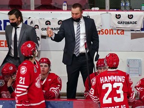 Cody Mapes, in the black suit, is in his first season as head coach and general manager of the SJHL's Weyburn Red Wings.