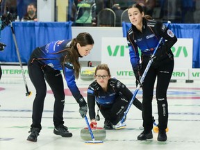 Stephanie Schmidt, left, and Jennifer Armstrong, right, sweep a shot thrown by Jolene Campbell of the Highland Curling Club's Chelsea Carey during a recent game at the Scotties Tournament of Hearts in Assiniboia. Hali Booth/Expressions Photography.