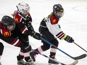 PS Cyclones Maizie White, from left, and Lily Wilson try to keep the puck away from Rebels White Brooklyn Strueby in U11 C girls hockey at the Co-Operators Centre on Tuesday, The Rebels White defeated the Cyclones 4-0.
TROY FLEECE / Regina Leader-Post