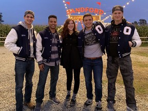 Actors Anthony Timpano (from left), Aason Nadjiwon, Zane Clifford and William Edward pose for a photo with Stephanie Perkins, who wrote the novel There's Someone Inside Your House. It was turned into a movie that's currently airing on Netflix.