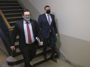 Premier Scott Moe, right, and Health Minister Paul Merriman, left, arrive to a press conference at the Legislative Building on Jan. 24, 2022.