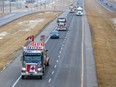 Trucks in the “Freedom Convoy” head east on the Trans-Canada Highway east of Calgary on Jan. 24, 2022.