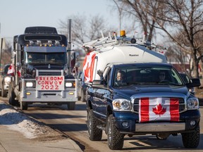 A group of vehicles supporting the Freedom Convoy travel along 8th St. in Saskatoon on Saturday, Feb. 12, 2022.