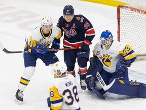 The Regina Pats' Connor Bedard, 98, is shown in front of Saskatoon Blades goalie Nolan Maier on Saturday at SaskTel Centre, where the home side won 6-2.