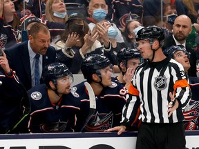 Columbus Blue Jackets head coach Brad Larsen discusses a call with Lumsden-born NHL referee Peter MacDougall during an Oct. 14 game between the host Blue Jackets and Arizona Coyotes.