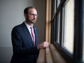 Saskatchewan NDP Leader Ryan Meili stands at the window in a stairwell at the Saskatchewan Legislative Building in Regina, Saskatchewan on Sept. 28, 2021.