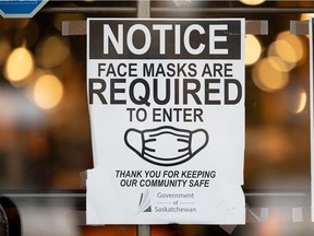 A sign shows that a mask is required to enter an indoor space. The Sask. government has said all remaining COVID-19-related restrictions will be lifted Feb. 28, but an emergency order will be in place to allow redeployment of health care workers to manage the pandemic.