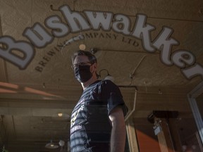 Grant Frew, bar manager of Bushwakker stands for a portrait on Tuesday. Frew said the proposed lifting of restrictions may not have an immediate, positive effect on many restaurants.