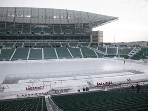 Crews get a curling rink ready inside Mosaic stadium before the FROST festival on Friday, February 4, 2022 in Regina.