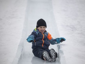 Porter Barns slides down an ice slide during the FROST Regina festival at Confederation Park in Regina on Sunday, February 6.