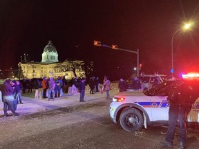 Protesters wave to oncoming traffic on the corner of Albert Street and 20th Avenue on Feb. 6, 2022 in Regina.