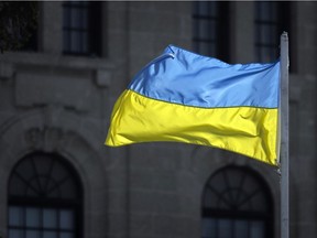 The flag of Ukraine flies in front of the Saskatchewan Legislative Building on Feb. 25, 2022 in Regina.