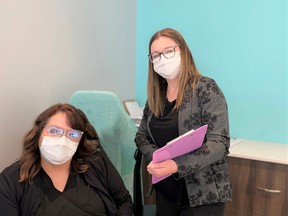 Dr. Amanda Beaudry (right) manages a staff of 50 at multiple clinics in Saskatoon. Here, Dr. Beaudry confers with staff member Pamela Wyatt-Painchaud (left). Photo: Jeannie Armstrong