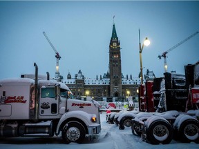 Trucks block a street in front of Parliament Hill during the protest against Covid-19 mandates, in Ottawa on Feb. 18, 2022. Canadian police on Thursday began a massive operation to clear the trucker-led protests against Covid health rules clogging the capital for three weeks, with several arrests made.