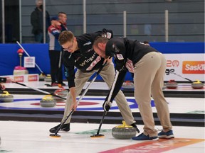 Lead Trent Knapp, left, and second Mike Armstrong sweep a rock into the house during Friday's action at the SaskTel Tankard Saskatchewan men's curling championship in Whitewood. Kelly Knapp, Trent's twin brother and skip of the Highland team, beat Saskatoon's Colton Flasch 8-7 in a B-event semifinal on Friday.
