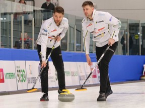 Kirk Muyres, left, and Braeden Moskowy of Matt Dunstone's Highland team, sweep a rock during Thursday's action at the SaskTel Saskatchewan Tankard men's curling championship in Whitewood. Dunston advanced to Friday's A-event final with a 10-2 win over Swift Current's Shaun Meachem.