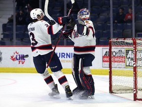 Regina Pats defenceman Luke Bateman congratulates goaltender Kelton Pyne on Friday following his first WHL shutout — a 5-0 victory over the Calgary Hitmen at the Brandt Centre.