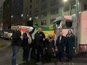 A photo shows Conservative MPs Warren Steinley, Kevin Waugh, Andrew Scheer, Fraser Tolmie, Rosemarie Falk and Sen. Denise Batters grinning in front of one of the protest trucks, which have been barricading roads and honking horns in the city almost non-stop since Saturday.