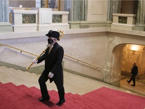 Sergeant-at-Arms Terry Quinn climbs stairs before the Throne Speech at the Legislative Building In November 2020