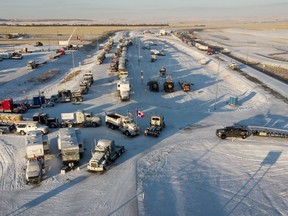 A truck convoy of anti-COVID-19 vaccine mandate demonstrators block the highway on Feb. 2 at the busy U.S. border crossing in Coutts, Alta.