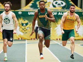 Usheoritse Itsekiri, centre, of the University of Regina Cougars races in the 60-metre sprint during the University of Alberta Golden Bears indoor track and field meet. Itsekiri, a native of Nigeria, finished first in the sprint.