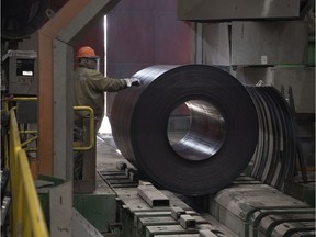 A worker marks a coil of steel at Evraz in Regina.