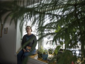 Yvette Crane of Regina Energy Transition, a group of local residents and organizations that discuss how to support Regina city council's efforts to address climate change and achieve a just transition to renewable energy, sits for a portrait inside here home on Thursday, March 3, 2022 in Regina.