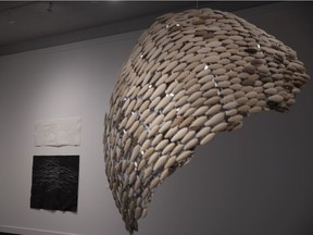 Peter Tucker’s monumental sculpture Holon is a spiral comprised of dozens of oblongs of different varieties of wood. It’s shown here at the Art Gallery of Regina on Monday, March 21, 2022.