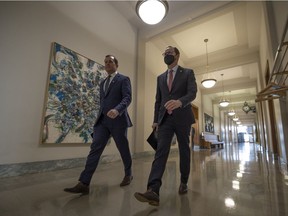 Finance critic Trent Wotherspoon and outgoing NDP leader Ryan Meili walk towards a press conference on budget day in 2022.