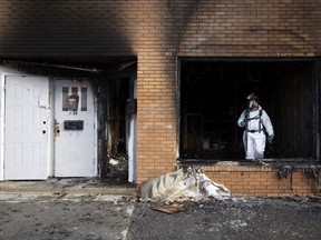 Regina Fire and Protective Services investigates a building on Halifax Street and 12th Avenue after a fire was extinguished earlier in the morning on March 25, 2022 in Regina. The unit is attached to a building that was destroyed after a blaze ripped through it in January.