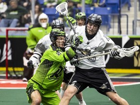 SASKATOON, SK--MARCH 26/2022 - 0327 Sports RUSH - Saskatchewan Rush defenceman Conner McClelland (21) battles for the ball with Calgary Roughnecks forward Tanner Cook (12) during first half NLL action in Saskatoon, SK on Saturday, March 26, 2022.