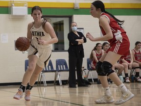 Katie Elliott, left, of the Luther Lions senior girls basketball team scored 26 points in her team's 49-42 city-final victory over the Balfour Bears on Tuesday.
