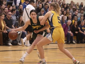 Meg Weisgerber, left, of the Campbell Tartans is guarded by the Harvest City Reapers' Severyn Ferrara Horne in the Regina Intercollegiate Basketball League's senior girls Blue Division final at Luther College High School.