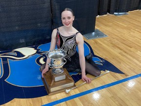 Julee Stewart of the Sundown Optimist Buffalo Gals is shown with the trophy she received for winning the women's division at the Congressional Cup baton twirling competition in Belair, Md., on Sunday.