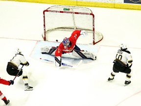 Rylen Roersma scores on Regina Pats goalie Drew Sim on Saturday at the Brandt Centre. The Wheat Kings' Nolan Ritchie is on the right.