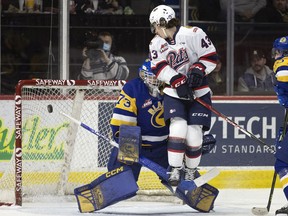 Regina Pats' Tanner Howe jumps out of the way of a shot in front Saskatoon Blades goalie Nolan Maier during Wednesday's WHL game at the Brandt Centre.
