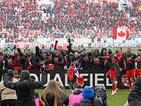 Members of the Canadian men's soccer team celebrate Sunday at BMO Field after clinching a berth in the 2022 FIFA World Cup.