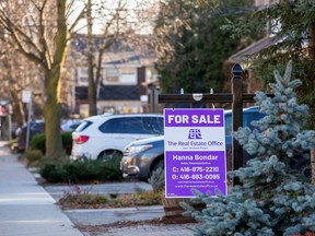 A for sale sign is displayed outside a home in Toronto, Ontario in Toronto, Ontario, Canada December 13, 2021. REUTERS/Carlos Osorio